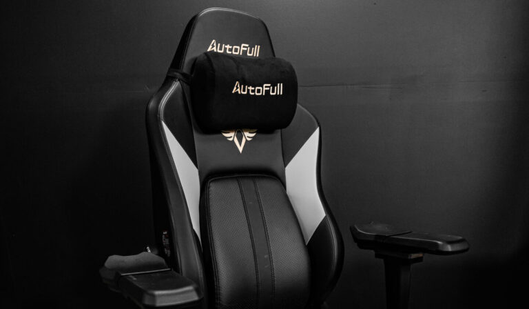 Autofull M6 black and white chair with a pillow on it